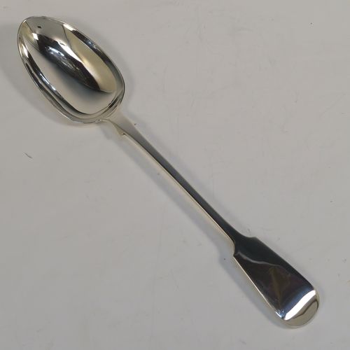 A handsome Antique Victorian Sterling Silver Fiddle pattern stuffing spoon, having a very plain handle with pip on reverse, and a plain oval bowl with shoulders above. This elegant antique silver serving spoon was made by the best Victorian flatware maker George Adams of London in 1854. The dimensions of this fine hand-made antique silver stuffing spoon are length 30.5 cms (12 inches), and it weighs approx. 122g (3.9 troy ounces).  