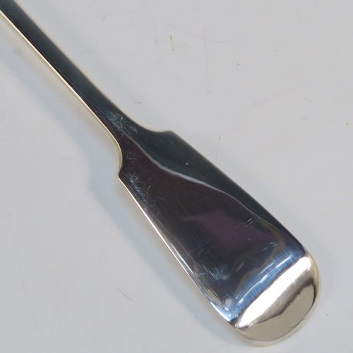 A handsome Antique Victorian Sterling Silver Fiddle pattern stuffing spoon, having a very plain handle with pip on reverse, and a plain oval bowl with shoulders above. This elegant antique silver serving spoon was made by the best Victorian flatware maker George Adams of London in 1854. The dimensions of this fine hand-made antique silver stuffing spoon are length 30.5 cms (12 inches), and it weighs approx. 122g (3.9 troy ounces).  