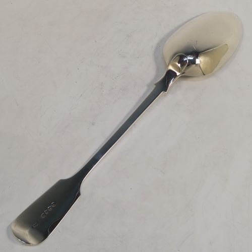 A handsome Antique Victorian Sterling Silver Fiddle pattern stuffing spoon, having a very plain handle with pip on reverse, and a plain oval bowl with shoulders above. This elegant antique silver serving spoon was made by the best Victorian flatware maker George Adams of London in 1884. The dimensions of this fine hand-made antique silver stuffing spoon are length 30.5 cms (12 inches), and it weighs approx. 130g (4.2 troy ounces).   