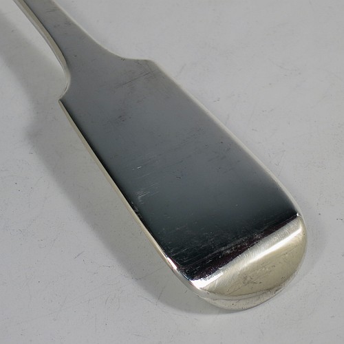 An Antique Georgian Sterling Silver heavy stuffing spoon in the Fiddle pattern, having a very plain handle with pip on reverse, and a plain oval bowl with shoulders above. Made by Clement Cheese of London in 1828. The dimensions of this fine hand-made antique silver stuffing spoon are length 30.5 cms (12 inches), and it weighs approx. 152g (4.9 troy ounces).    