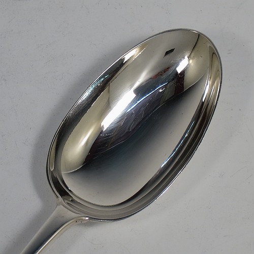 An Antique Edwardian Sterling Silver heavy stuffing spoon in the Old English pattern, having a very plain handle with pip on reverse, and a plain oval bowl. Made by Jackson and Fullerton of London in 1907. The dimensions of this fine hand-made antique silver stuffing spoon are length 31 cms (12.25 inches), and it weighs approx. 156g (5 troy ounces).    