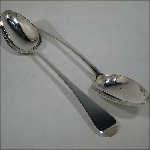 A very handsome pair of Antique Georgian Sterling Silver stuffing or serving spoons in the Old English pattern, having very plain handles with pips on reverse, and plain oval bowls. Made by Eley, Fearn, and Chawner of London in 1811. The dimensions of this fine hand-made pair of antique silver serving or stuffing spoons are length 26.5 cms (10.5 inches), and they have a total weight of approx. 195g (6.3 troy ounces).    