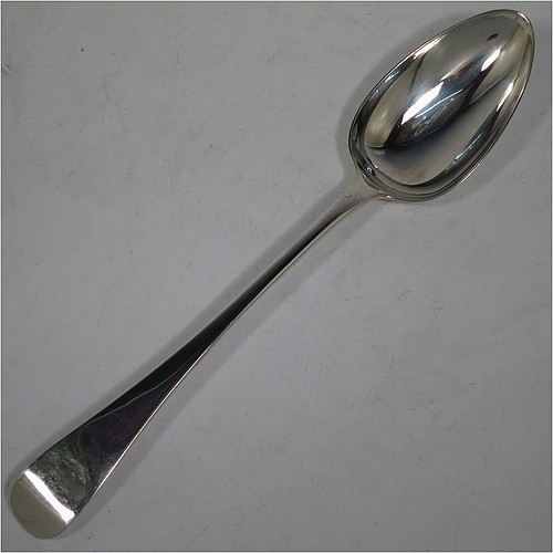 A very handsome pair of Antique Georgian Sterling Silver stuffing or serving spoons in the Old English pattern, having very plain handles with pips on reverse, and plain oval bowls. Made by Eley, Fearn, and Chawner of London in 1811. The dimensions of this fine hand-made pair of antique silver serving or stuffing spoons are length 26.5 cms (10.5 inches), and they have a total weight of approx. 195g (6.3 troy ounces).    