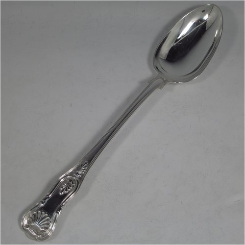 An Antique Georgian sterling silver stuffing spoon in the double-struck Kings pattern, having a fancy handle with hand-chased shell, scroll, and reeded decoration, and a plain oval bowl with shoulders above. Made by William Eley & William Fearn of London in 1823. The dimensions of this fine hand-made silver stuffing spoon are length 31 cms (12.25 inches), and it weighs approx. 200g (6.5 troy ounces).