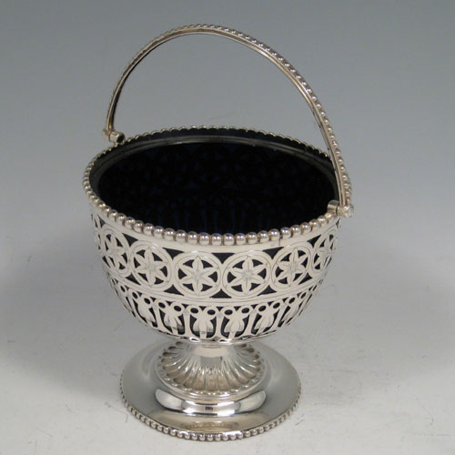    Antique Victorian sterling silver sugar basket with hand-engraved and pierced decoration, and with bead edges, and blue-glass liner. Made by Hirons & Plante of Birmingham in 1862. Height (including handle) 18 cms (7 inches), diameter 11.5 cms (4.5 inches). Weight approx. 6.5 troy ounces (202g). 