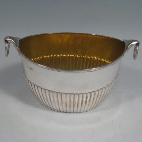 Antique Victorian sterling silver sugar bowl, having an oval body with hand-chased half-fluted decoration and reeded border, with two cast lobed handles and rings. Made in London in 1880. Height 9 cms (3.5 inches), length 17 cms (6.75 inches), width 10 cms (4 inches). Weight approx. 250g (8.1 troy ounces).