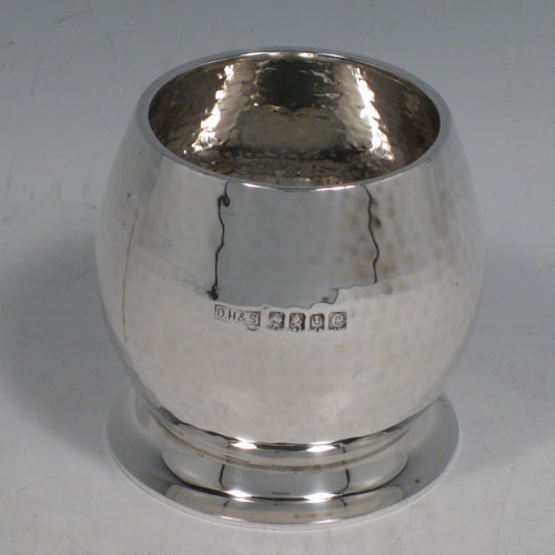 Sterling silver Arts and Crafts style sugar bowl, having a round convex body with a hand-hammered finish, sitting on a collet foot. Made in Glasgow in 1927. Height 7 cms (2.75 inches), diameter 7 cms (2.75 inches). Weight approx. 115g (3.7 troy ounces).