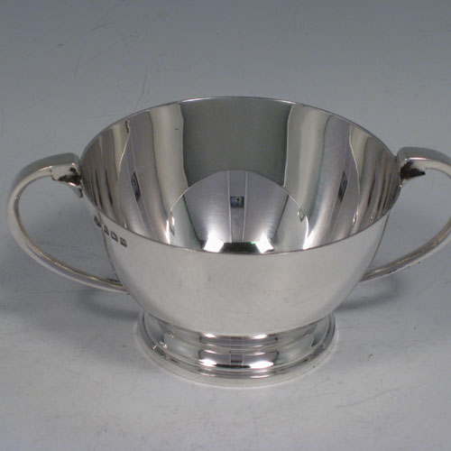 Sterling silver Art Deco style round sugar bowl with two handles and sitting on a collet foot. Made by the Adie Brothers of Birmingham in 1936.  Height 5.5 cms (2.25 inches), diameter at top 9 cms (3.5 inches). Weight approx. 145g (4.7 troy ounces).