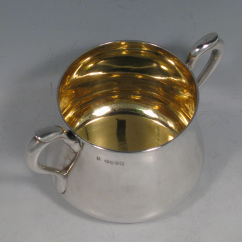 Antique Victorian sterling silver sugar bowl, having a plain round baluster body, with two scroll side-handles, a gold-gilt interior, and sitting on a flat base. Made by John Hunt and Robert Roskell (late Storr & Mortimer) of London in 1878. The dimensions of this fine hand-made silver sugar bowl are length 15 cms (6 inches), height 9 cms (3.5 inches), and it weighs approx. 274g (8.8 troy ounces).   