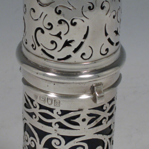 Antique Edwardian sterling silver sugar caster, having a round straight-sided body with hand-pierced decoration, a blue-glass liner, and a bayonet-fit hand-pierced pull-off lid with a cast knurl finial. Made by the Haseler Brothers of London in 1905. The dimensions of this fine hand-made silver sugar caster are height 17 cms (6.75 inches), diameter 5 cms (2 inches), and it weighs approx. 123g (4 troy ounces).  