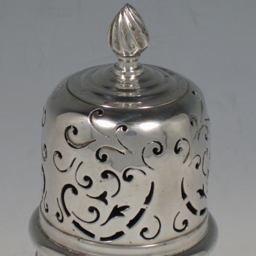 Antique Edwardian sterling silver sugar caster, having a round straight-sided body with hand-pierced decoration, a blue-glass liner, and a bayonet-fit hand-pierced pull-off lid with a cast knurl finial. Made by the Haseler Brothers of London in 1905. The dimensions of this fine hand-made silver sugar caster are height 17 cms (6.75 inches), diameter 5 cms (2 inches), and it weighs approx. 123g (4 troy ounces).  