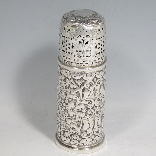 Antique Victorian sterling silver sugar caster, having a round straight-sided body with hand-chased floral decoration, a hand-pierced screw-off lid, and sitting on a collet foot. Made by Henry Wilkinson of London in 1896. The dimensions of this fine hand-made silver sugar caster are height 14 cms (5.5 inches), diameter 4.5 cms (1.75 inches), and it weighs approx. 121g (3.9 troy ounces).   