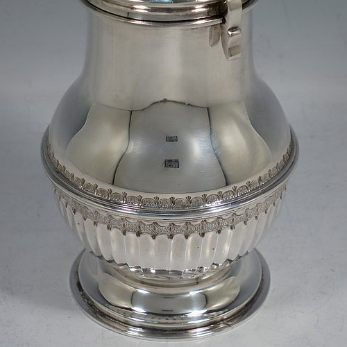 An Antique Edwardian Sterling Silver large sugar caster in a George II style, having a bellied body with hand-chased lower fluting, with applied reeded borders, a bayonet-fit pull-off hand-pierced lid with cast finial, and sitting on a pedestal foot. Made by Nathan & Hayes of Chester in 1904. The dimensions of this fine hand-made antique silver sugar caster are height 20.5 cms (8 inches), width 8 cms (3 inches), and it weighs approx. 328g (10.6 troy ounces).    