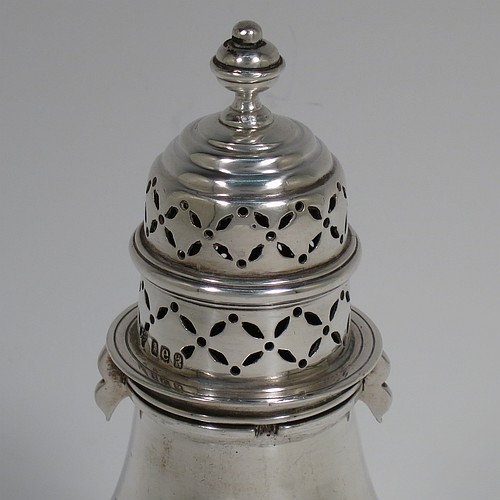 A heavy Antique Victorian Britannia Standard Silver sugar caster, having a plain round bellied body with an applied reeded central girdle, a hand-pierced lid with bayonet fit and cast urn-shaped finial, and sitting on a pedestal foot. Made by Charles Stuart Harris of London in 1900. The dimensions of this fine hand-made antique silver sugar caster are height 14 cms (5 inches), diameter of belly 6 cms (2.3 inches), and it weighs approx. 197g (6.4 troy ounces).    