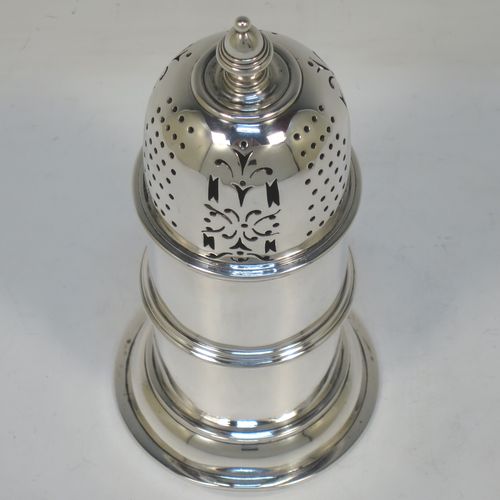 A very handsome Antique Victorian Sterling Silver sugar caster, in a Queen Anne lighthouse style, having a plain round straight-sided body with applied reeded borders, a hand-pierced bayonet fit lid and a cast finial, and all sitting on a round collet foot. Made by Sibray, Hall and Co., of London in 1894. The dimensions of this fine hand-made antique silver sugar caster are height 16.5 cms (6.5 inches), diameter at base 8 cms (3 inches), and it weighs approx. 253g (8.2 troy ounces).   