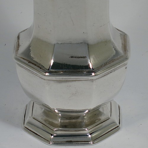 An Antique Georgian Sterling Silver George I heavy sugar caster, having a plain octagonal panelled and bellied body with applied and hand-chased reeded borders, a pull-off hand-pierced lid with cast octagonal finial, and all sitting on a pedestal foot. Made by Thomas Banford of London in 1725. The dimensions of this fine hand-made antique silver sugar caster are height 17 cms (6.75 inches), width 6.5 cms (2.5 inches), and it weighs approx. 243g (7.8 troy ounces). Please note that this item is crested.   