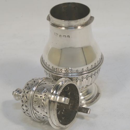 A heavy and very handsome Sterling Silver sugar caster, having a round bellied body with an applied reeded central girdle with hand-chased fluted decoration below, a hand-pierced lid with bayonet fit and cast urn-shaped finial, and sitting on a pedestal foot. Made by S. Blankensee and Sons Ltd. of Birmingham in 1929. The dimensions of this fine hand-made silver sugar caster are height 16 cms (6.3 inches), diameter of belly 6.5 cms (2.5 inches), and it weighs approx. 216g (7 troy ounces).  