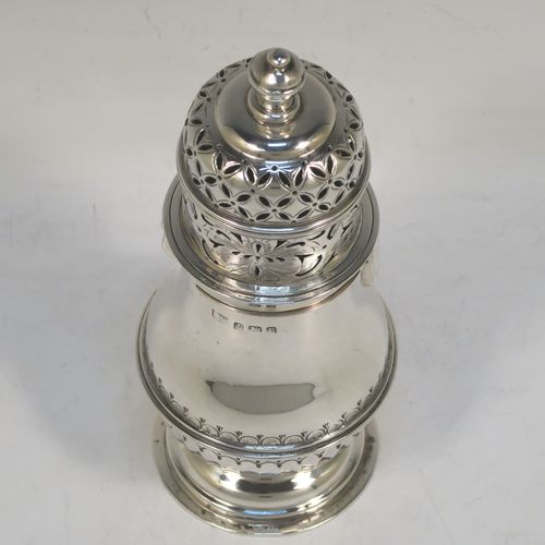 A heavy and very handsome Sterling Silver sugar caster, having a round bellied body with an applied reeded central girdle with hand-chased fluted decoration below, a hand-pierced lid with bayonet fit and cast urn-shaped finial, and sitting on a pedestal foot. Made by S. Blankensee and Sons Ltd. of Birmingham in 1929. The dimensions of this fine hand-made silver sugar caster are height 16 cms (6.3 inches), diameter of belly 6.5 cms (2.5 inches), and it weighs approx. 216g (7 troy ounces).  