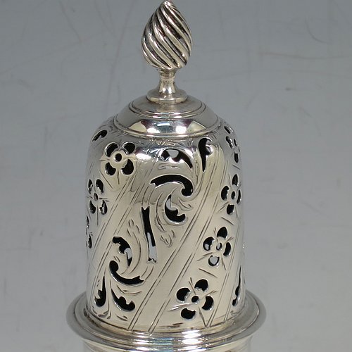 An Antique Georgian Sterling Silver heavy sugar caster, having a plain bellied body with applied and hand-chased reeded borders, a pull-off hand-pierced lid with cast swirl finial, all sitting on a pedestal foot. Made by Robert Peaston of London in 1770. The dimensions of this fine hand-made antique silver sugar caster are height 18 cms (7 inches), width 6 cms (2.3 inches), and it weighs approx. 219g (7 troy ounces).   