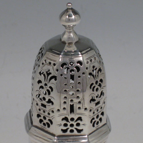    Antique Georgian sterling silver sugar caster, having an octagonal baluster body, hand-pierced removable top with cast finial, and sitting on a collet foot. Made in the George I period and hallmarked for London in 1725. Height 15 cms (6 inches), width 6 cms (2.25 inches). Weight approx. 175g (5.6 troy ounces).