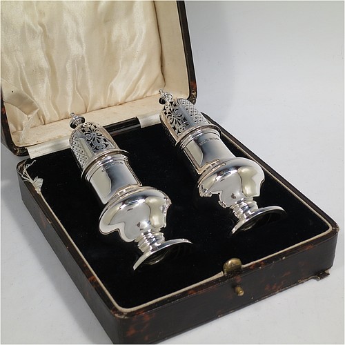 A very handsome pair of Sterling Silver sugar casters in a George II style, having plain round baluster bodies, pull-off hand-pierced lids with urn finials, and sitting on pedestal feet, all in their original cream satin and black velvet-lined presentation box. Made by B. Streete and Co., of Birmingham in 1930. The dimensions of this fine pair of hand-made silver sugar casters are height 14 cms (5.5 inches), width 5 cms (2 inches), with a total weight of approx. 178g (5.7 troy ounces). Please note that silk retainer hinge of the box is damaged.  