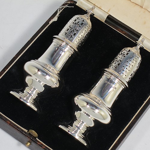 A very handsome pair of Sterling Silver sugar casters in a George II style, having plain round baluster bodies, pull-off hand-pierced lids with urn finials, and sitting on pedestal feet, all in their original cream satin and black velvet-lined presentation box. Made by B. Streete and Co., of Birmingham in 1930. The dimensions of this fine pair of hand-made silver sugar casters are height 14 cms (5.5 inches), width 5 cms (2 inches), with a total weight of approx. 178g (5.7 troy ounces). Please note that silk retainer hinge of the box is damaged.  