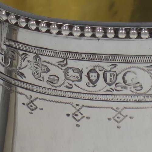 An Antique Victorian Sterling silver sugar and creamer set, having oval bodies with hand-engraved floral decoration, applied beaded borders, gold-gilt interiors, and angular handles. Made by Goldsmiths & Silversmiths of London in 1881. The dimensions of this fine hand-made antique silver cream and sugar set are height of creamer 9 cms (3.5 inches), length of sugar bowl 16 cms (6.25 inches), and with a total weight approx. 303g (9.8 troy ounces).   