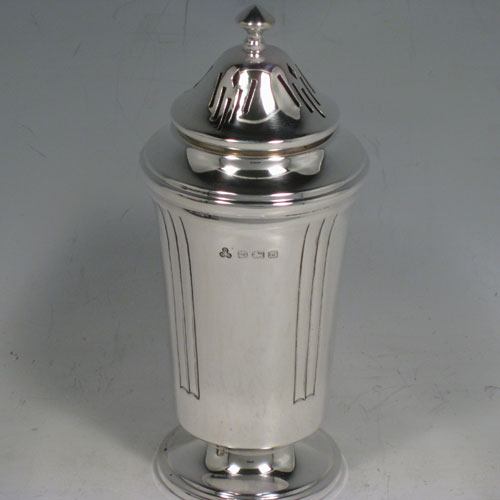 Sterling silver pair of Art Deco sugar caster and creamer set, having plain round bodies with tapering sides and reeded hand-chased decoration, a pull-off hand-pierced lid on the caster and a loop handle on the creamer, all sitting on round pedestal feet, and in their original satin and velvet-lined presentation box. Made in Birmingham in 1938. The dimensions of this fine hand-made silver sugar caster and cream jug set are height of caster 14 cms (5.5 inches), length of cream jug (11 cms (4.3 inches), and the total weight is approx. 217g (7 troy ounces).  