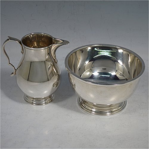 A Sterling Silver sugar and creamer set, having plain round bellied bodies, applied reeded borders, a sparrow-beak spout, and sitting on collet feet. Made by Robert Comyns of London in 1965. The dimensions of this fine hand-made silver sugar and creamer set are height of cream jug 7.5 cms (3 inches), diameter of bowl 9 cms (3.5 inches), and they weigh a total of approx. 225g (7.3 troy ounces).   