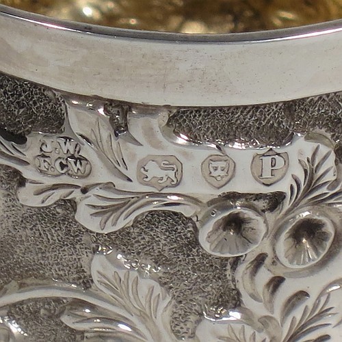 A beautiful Antique Victorian Sterling Silver sugar and creamer set, having round bodies with hand-chased floral decoration, and with gold-gilt interiors, all sitting on flat bases. Made by James Wakely & Frank Clarke Wheeler of London in 1890. The dimensions of this fine hand-made antique silver sugar and creamer set are diameter of sugar bowl 8 cms (3 inches), height of cream jug 6.5 cms (2.5 inches), and with a total weight of 133g (4.3 troy ounces).    