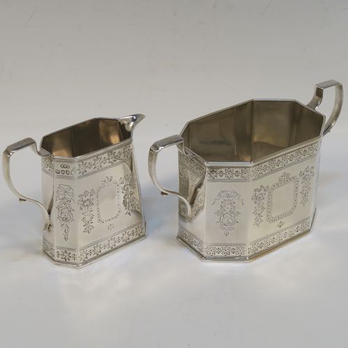 A very pretty Antique Victorian Sterling Silver sugar and creamer set, having octagonal panelled bodies with straight sides and hand-engraved floral decoration, with applied reeded borders, scoll sider handles, and all sitting on flat bases. This beautiful sugar and cream set was made by Henry William Curry of London in 1882. The dimensions of this fine hand-made antique silver cream and sugar set are height of creamer 9.5 cms (3.75 inches), length of sugar bowl 16.5 cms (6.5 inches), and with a total weight approx. 336g (10.8 troy ounces).   