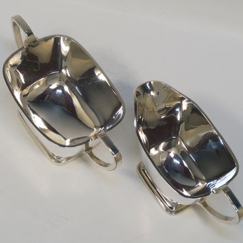 A heavy and elegant Sterling Silver pair of Art Deco sugar bowl and creamer set, having plain rectangular bodies with tapering sides and rounded corners, with cast scroll side-handles, and all sitting on pedestal feet. This handsome silver sugar and cream set was made by Charles Fletcher  of Sheffield in 1939. The dimensions of this fine hand-made silver Art Deco style sugar bowl and cream jug set are height of cream jug 8 cms (3 inches), width of sugar bowl (inc. handles) 18 cms (7 inches), and the total weight is approx. 461g (14.9 troy ounces).   