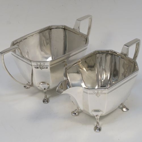 A heavy and elegant Sterling Silver pair of Art Deco sugar bowl and creamer set, having plain octagonal panelled bodies with tapering sides, an upper band of hand-engraved reeded and sun-burst decoration, with cast flat-topped side-handles, and all sitting on four cast feet. This handsome silver sugar and cream set was made by Emile Viner of Sheffield in 1947. The dimensions of this fine hand-made silver Art Deco style sugar bowl and cream jug set are length of sugar bowl (inc. handles) 16.5 cms (6.5 inches), width of sugar bowl 8.5 cms (3.3 inches), and the total weight is approx. 470g (15 troy ounces).   