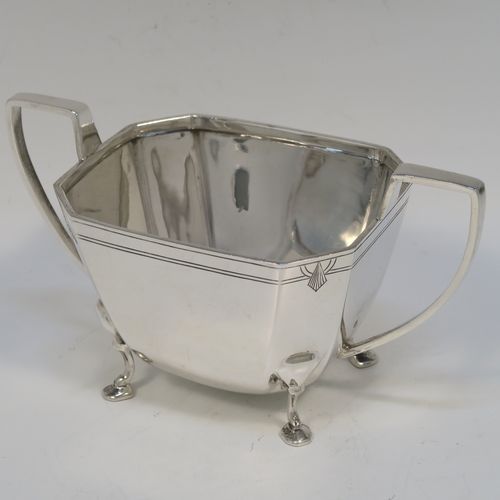 A heavy and elegant Sterling Silver pair of Art Deco sugar bowl and creamer set, having plain octagonal panelled bodies with tapering sides, an upper band of hand-engraved reeded and sun-burst decoration, with cast flat-topped side-handles, and all sitting on four cast feet. This handsome silver sugar and cream set was made by Emile Viner of Sheffield in 1947. The dimensions of this fine hand-made silver Art Deco style sugar bowl and cream jug set are length of sugar bowl (inc. handles) 16.5 cms (6.5 inches), width of sugar bowl 8.5 cms (3.3 inches), and the total weight is approx. 470g (15 troy ounces).   