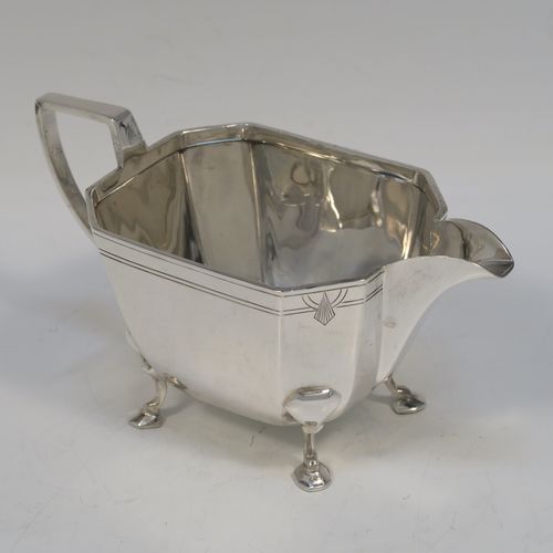 A heavy and elegant Sterling Silver pair of Art Deco sugar bowl and creamer set, having plain octagonal panelled bodies with tapering sides, an upper band of hand-engraved reeded and sun-burst decoration, with cast flat-topped side-handles, and all sitting on four cast feet. This handsome silver sugar and cream set was made by Emile Viner of Sheffield in 1947. The dimensions of this fine hand-made silver Art Deco style sugar bowl and cream jug set are length of sugar bowl (inc. handles) 16.5 cms (6.5 inches), width of sugar bowl 8.5 cms (3.3 inches), and the total weight is approx. 470g (15 troy ounces).   