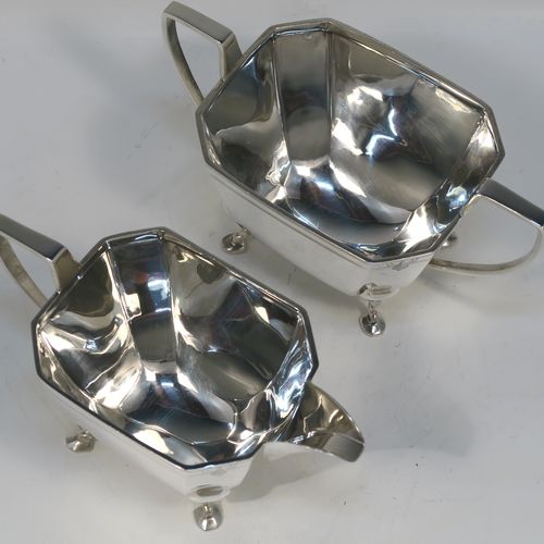 A heavy and elegant Sterling Silver pair of Art Deco sugar bowl and creamer set, having plain octagonal panelled bodies with tapering sides, an upper band of hand-engraved reeded and sun-burst decoration, with cast flat-topped side-handles, and all sitting on four cast feet. This handsome silver sugar and cream set was made by Emile Viner of Sheffield in 1947. The dimensions of this fine hand-made silver Art Deco style sugar bowl and cream jug set are length of sugar bowl (inc. handles) 16.5 cms (6.5 inches), width of sugar bowl 8.5 cms (3.3 inches), and the total weight is approx. 470g (15 troy ounces).   