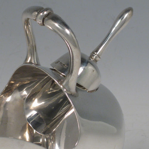 Antique Edwardian sterling silver sugar scuttle, having a plain body, a cast scroll handle, an original scoop, and sitting on a pedestal foot. Made by the Deakin Brothers of Sheffield in 1909. The dimensions of this fine hand-made silver sugar scuttle are length 16 cms (6.25 inches), height 14 cms (5.5 inches), width 7 cms (2.75 inches), and it weighs approx. 256g (8 troy ounces).