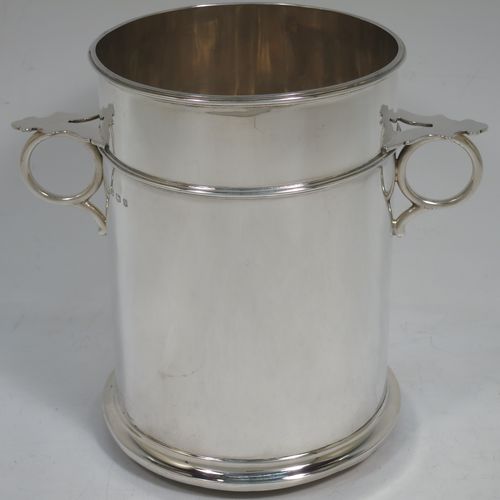 A very handsome Sterling Silver syphon stand, having a plain round body with straight sides, two ring side-handles with flat thumb-pieces, applied reeded borders and upper girdle, and sitting on a flat wood-turned coaster base. Made by James Dixon and Sons of Sheffield in 1933. The dimensions of this fine hand-made silver siphon stand are diameter 12 cms (4.75 inches), height 17 cms (6.75 inches), and it weighs approx. 450g (14.5 troy ounces).   