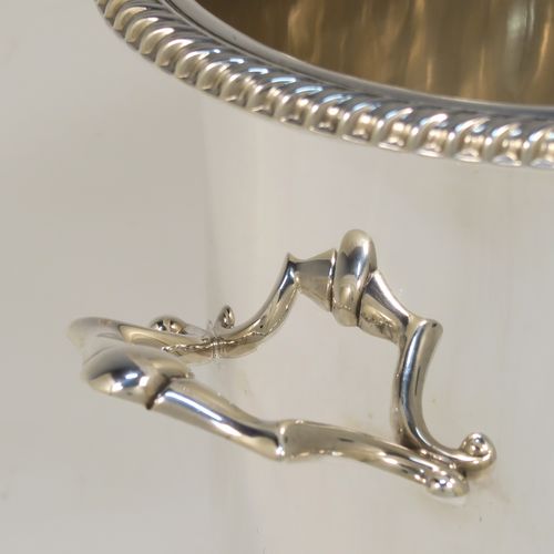 A very handsome Sterling Silver syphon stand, having a plain round body with straight sides, two cast scroll side-handles, an applied gadroon top border, and sitting on a collet foot. This elegant silver siphon stand was made by the Barker Brothers of Birmingham in 1932. The dimensions of this fine hand-made silver siphon stand are internal diameter 11.5 cms (4.5 inches), height 16 cms (6.3 inches), and it weighs approx. 616g (19.9 troy ounces).  