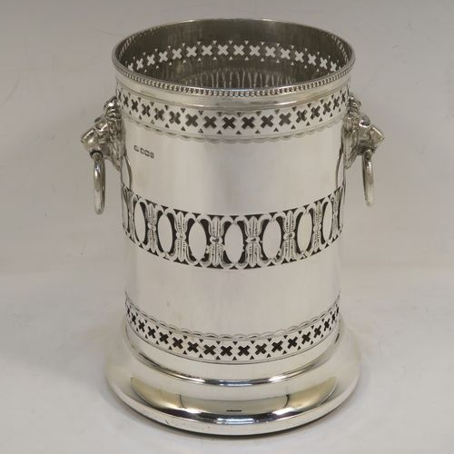 A very pretty Antique Sterling Silver syphon stand, having a round body with straight sides and hand-pierced decoration, with two cast lion-mask ring side-handles, an applied bead-edged top border, and all sitting on a pedestal foot. This elegant silver siphon stand was made by Richard Burbridge of Sheffield for Harrods in 1913. The dimensions of this fine hand-made silver siphon stand are internal diameter 10 cms (4 inches), height 16.5 cms (6.5 inches), and it weighs approx. 450g (14.5 troy ounces).  