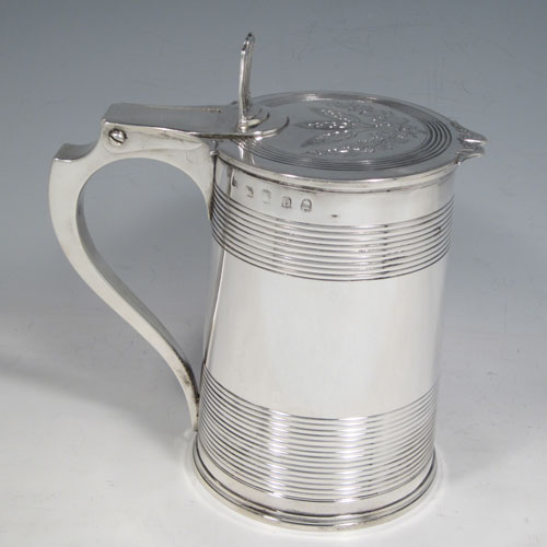 Antique Georgian sterling silver quart tankard, having a plain round body with tapering sides and hand-chased reeded decoration, a scroll handle with hinged lid and hand-pierced thumb-piece, the lid with hand-engraved barley and hops (for the making of beer) decoration. Made by Soloman Hougham of London in 1799. The dimensions of this fine hand-made silver tankard are height (including thumb-piece) 19 cms (7.5 inches), length 18 cms (7 inches), and it weighs approx. 855g (27.5 troy ounces).  