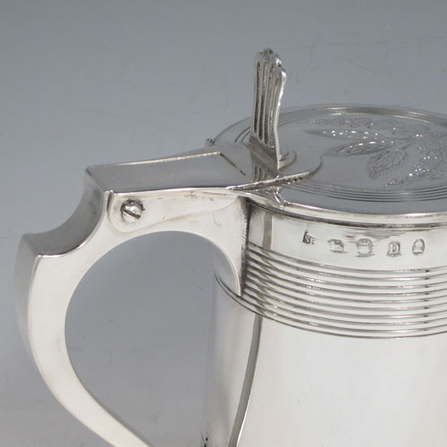 Antique Georgian sterling silver quart tankard, having a plain round body with tapering sides and hand-chased reeded decoration, a scroll handle with hinged lid and hand-pierced thumb-piece, the lid with hand-engraved barley and hops (for the making of beer) decoration. Made by Soloman Hougham of London in 1799. The dimensions of this fine hand-made silver tankard are height (including thumb-piece) 19 cms (7.5 inches), length 18 cms (7 inches), and it weighs approx. 855g (27.5 troy ounces).  