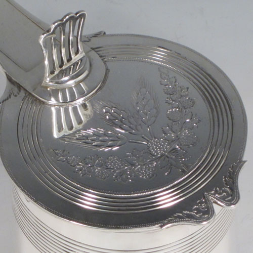 Antique Georgian sterling silver quart tankard, having a plain round body with tapering sides and hand-chased reeded decoration, a scroll handle with hinged lid and hand-pierced thumb-piece, the lid with hand-engraved barley and hops (for the making of beer) decoration. Made by Soloman Hougham of London in 1799. The dimensions of this fine hand-made silver tankard are height (including thumb-piece) 19 cms (7.5 inches), length 18 cms (7 inches), and it weighs approx. 855g (27.5 troy ounces).  