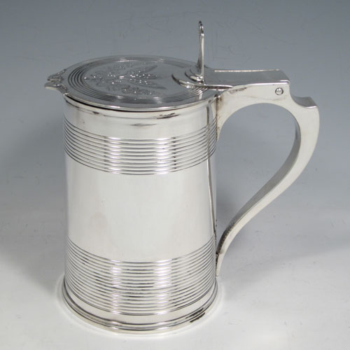 Antique Georgian sterling silver quart tankard, having a plain round body with tapering sides and hand-chased reeded decoration, a scroll handle with hinged lid and hand-pierced thumb-piece, the lid with hand-engraved barley and hops (for the making of beer) decoration. Made by Soloman Hougham of London in 1799. The dimensions of this fine hand-made silver tankard are height (including thumb-piece) 19 cms (7.5 inches), length 18 cms (7 inches), and it weighs approx. 855g (27.5 troy ounces).  