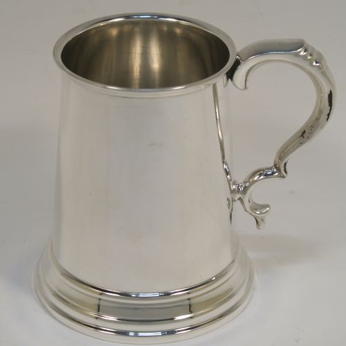 A very handsome George I style Sterling Silver half-pint tankard, having a plain round straight-sided body with tapering sides, a scroll side-handle, and all sitting on a collet foot. This elegant silver half-pint mug was made by S. Blanckensee and Sons of Birmingham in 1935. The dimensions of this fine hand-made silver tankard are height 11 cms (4.3 inches), diameter at top 7 cms (2.75 inches), and it weighs approx. 175g (5.6 troy ounces).   