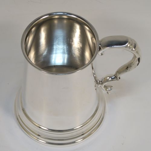 A very handsome George I style Sterling Silver half-pint tankard, having a plain round straight-sided body with tapering sides, a scroll side-handle, and all sitting on a collet foot. This elegant silver half-pint mug was made by S. Blanckensee and Sons of Birmingham in 1935. The dimensions of this fine hand-made silver tankard are height 11 cms (4.3 inches), diameter at top 7 cms (2.75 inches), and it weighs approx. 175g (5.6 troy ounces).   