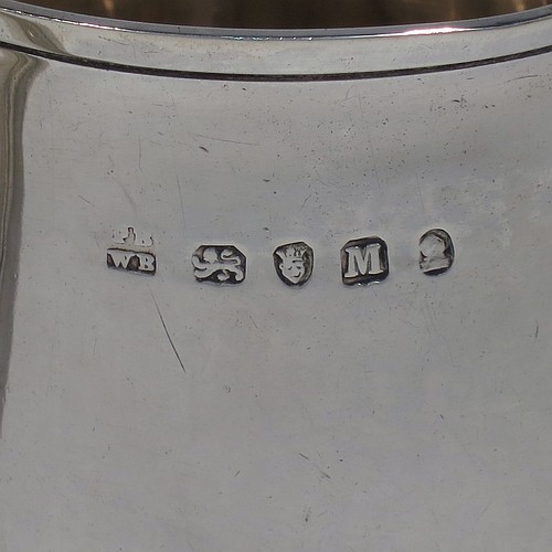 An Antique Georgian Sterling Silver pint tankard, having a plain round straight-sided body with hand-chased reeded borders, a scroll handle with heart-shaped terminal, and sitting on a collet foot. Made by Peter and William Bateman of London in 1804. The dimensions of this fine hand-made antique silver tankard are height 12 cms (4.75 inches), diameter at top 7.5 cms (3 inches), and it weighs approx. 315g (10.2 troy ounces).   