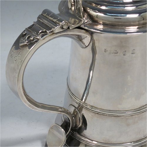 An Antique Georgian Sterling Silver lidded quart tankard, having a plain round straight-sided body, a hinged dome lid with cast scroll thumb-piece, a scroll handle with heart-shaped terminal, and sitting on a collet foot. Made by William Shaw & William Priest of London in 1758. The dimensions of this fine hand-made antique silver tankard are height 16.5 cms (6.75 inches), length 16.5 cms (6.5 inches), and it weighs approx. 620g (20 troy ounces).   