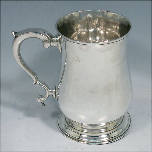 An Antique Georgian Sterling Silver half-pint tankard, having a plain round baluster body, a scroll handle, and sitting on a collet foot. Made by John Payne of London in 1759. The dimensions of this fine hand-made antique silver half-pint mug / tankard are height 10 cms (4 inches), diameter at top 7 cms (2.75 inches), and it weighs approx. 214g (6.9 troy ounces).   