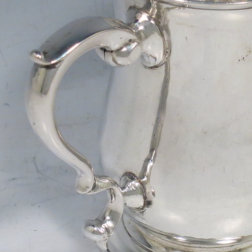 An Antique Georgian Sterling Silver half-pint tankard, having a plain round baluster body, a scroll handle, and sitting on a collet foot. Made by John Payne of London in 1759. The dimensions of this fine hand-made antique silver half-pint mug / tankard are height 10 cms (4 inches), diameter at top 7 cms (2.75 inches), and it weighs approx. 214g (6.9 troy ounces).   